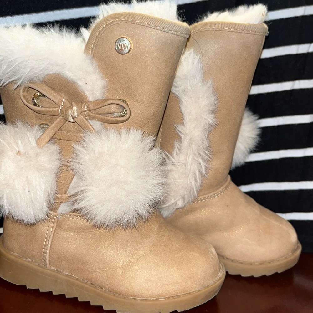 Cream tall boots with fur trim and sturdy sole
